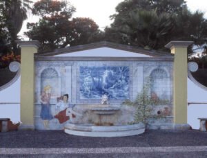 Trompe l’oeil tile mural and fountain with grottesque spout